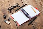 Office table with notepad, colorful pencils and supplies. View from above with copy space