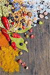 Colorful spices and herbs frame on a wooden background.