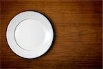 An image of an empty plate on a wooden background