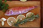 red mullet and lemon on wooden table