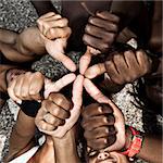 A group of mixed race people with hands doing thumbs up