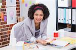 Portrait of female interior designer at office desk