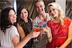 Young friends having a drink together at the bar