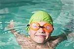 Cute kid swimming in the pool at the leisure center