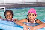 Cute little girls swimming in the pool at the leisure center