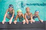 Cute swimming class in the pool at the leisure center