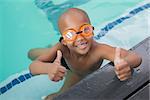 Cute little boy giving thumbs up at the pool at the leisure center