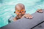 Little boy smiling in the pool at the leisure center