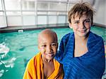 Little boys smiling by the pool at the leisure center