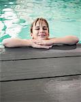 Little boy smiling in the pool at the leisure center