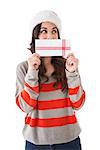 Festive brunette holding a gift on white background