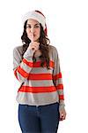 Festive brunette in santa hat keeping a secret on white background