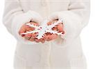 Cute little girl holding snowflake on white background