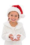 Festive little girl holding snowflake on white background