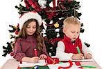 Festive little siblings drawing pictures on white background