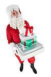 Happy santa claus holding pile of gifts on white background