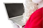 Father christmas using his laptop on white background