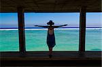 Beautiful woman with arms open on a beautiful tropical beach