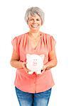 Portrait of a happy old woman putting money on  a piggy bank, isolated on a white background