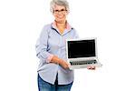 Happy elderly woman holding and showing something on a laptop