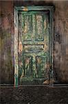 Closed old wooden door on grunge wall background