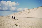 Surfers with surfboard on beach, Lacanau, France