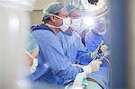 Doctors performing surgery in operating theater