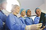 Surgeons looking at x-ray during surgery in operating theater