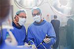 Portrait of doctors performing laparoscopic surgery in operating theater