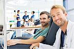 Portrait of smiling doctor and patient undergoing medical treatment in outpatient clinic