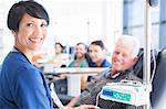 Portrait of smiling doctor assisting patient undergoing medical treatment in outpatient clinic