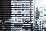 Young businessman standing in conference room looking out of window