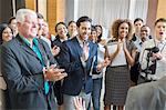 Group of people applauding after speech during conference