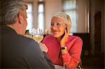 Older couple toasting each other with white wine