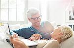 Older couple relaxing together on sofa