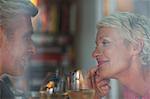 Older romantic couple drinking white wine