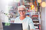 Businesswoman smiling at computer in home office