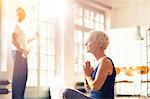 Older woman meditating on floor