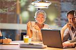 Businesswoman smiling in office meeting