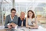 Business people smiling in office meeting