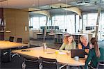 Businesswomen shaking hands in office meeting