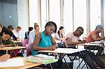 University students taking exam at classroom