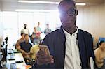 Portrait of university student with smartphone in classroom