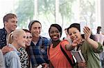 University students taking selfie in corridor during break