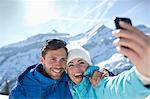 Couple taking selfie in snow