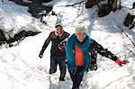 Couple climbing in snow