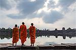Cambodia, Siem Reap, Angkor Wat complex. Monks in front of Angkor wat temple (MR)