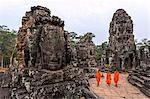 Cambodia, Siem Reap, Angkor Wat complex. Monks inside Bayon temple, at sunrise (MR)