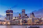 Europe, United Kingdom, England, London, City of London, skyline at dusk showing the Gherkin (30 St Mary Axe), the Cheesegrater (122 Leadenhall Street) and the Walkie-Talkie (20 Fenchurch Street) and the River Thames
