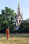 Europe, United Kingdom, England, London, Kensington, an attractive young woman standing in front of the Albert Memorial in Kensington Gardens MR